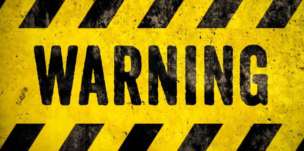 A yellow and black sign that says Warning