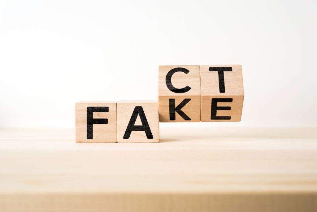 Wooden blocks reading fact and fake.