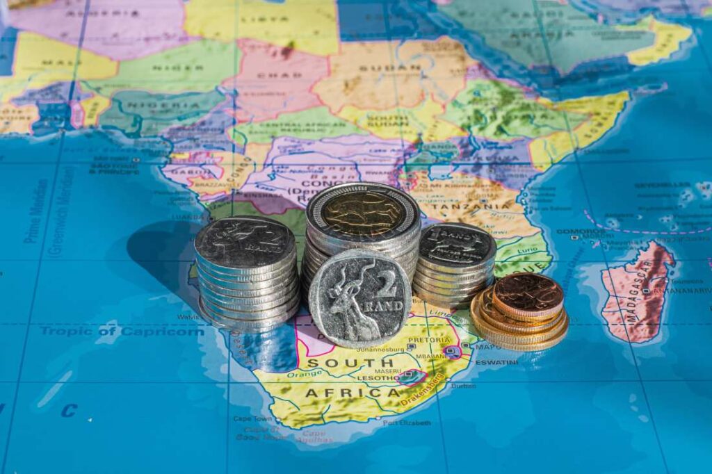 A stack of coins on a map of Africa.